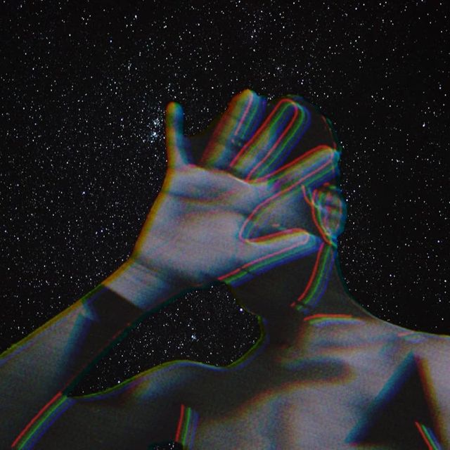 Photo of hands raised against a starfield with a chromatic split